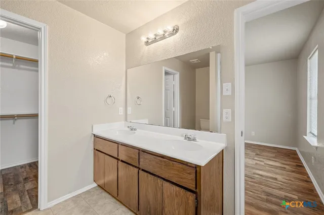a view of a bathroom with a sink and a mirror