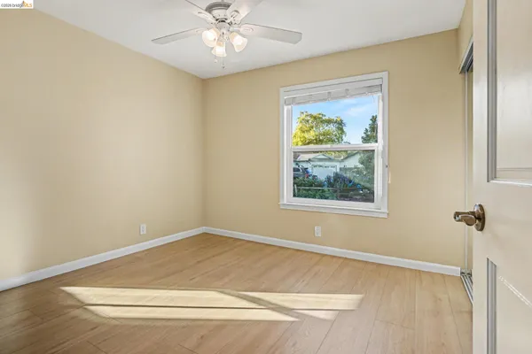 a view of a big room with wooden floor and windows in a room
