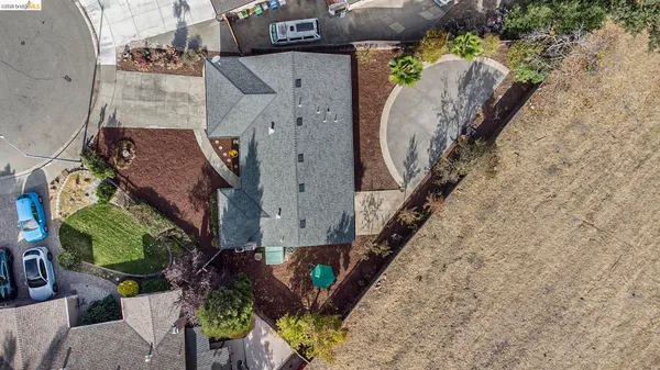 an aerial view of a house with outdoor space and a parking