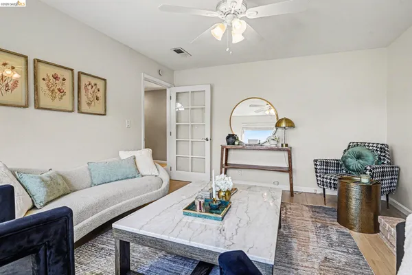 a living room with furniture and a chandelier