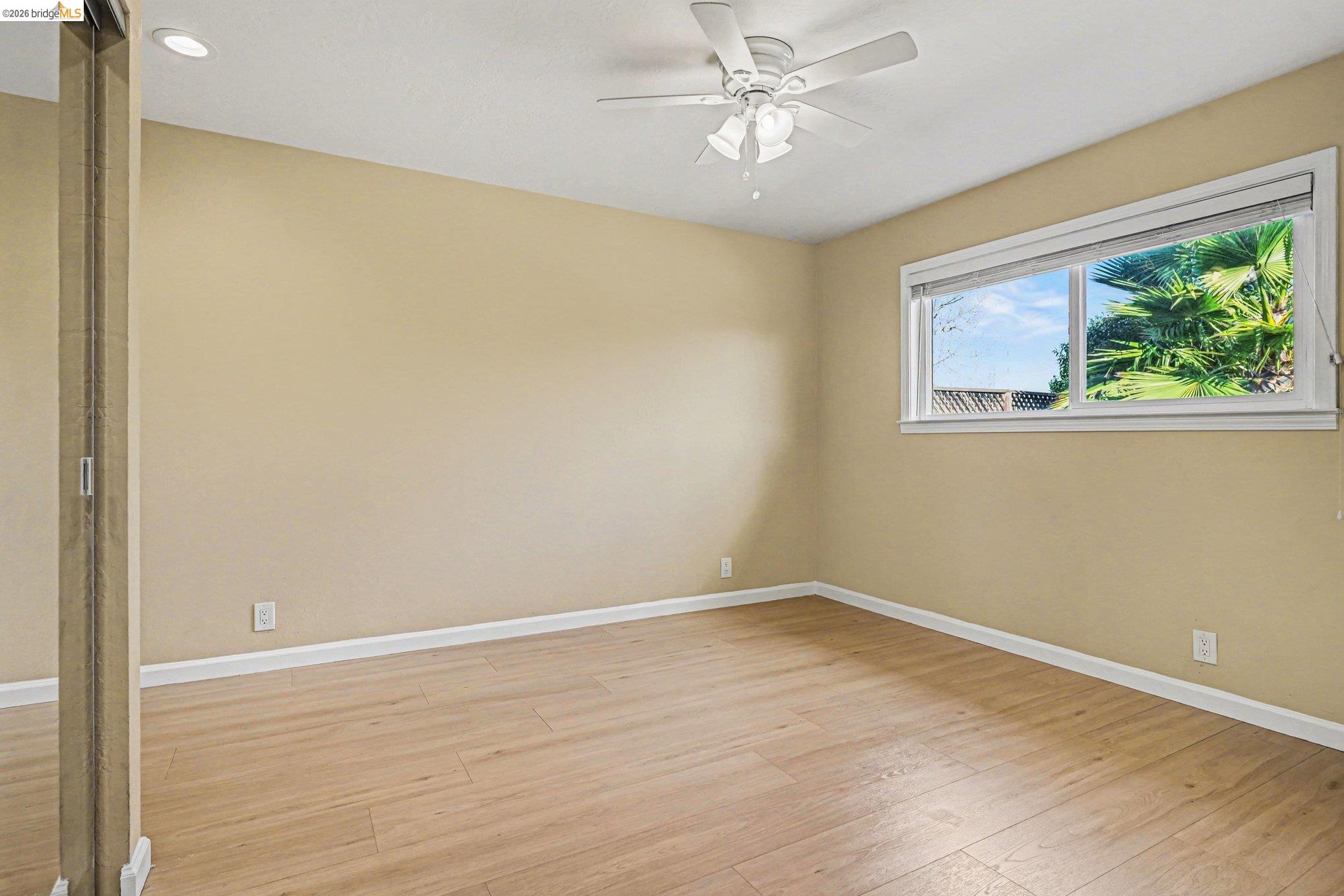 25 Marilyn Place San Ramon, CA 94583 - Photo 8 of 24 a view of an empty room with wooden floor and a window