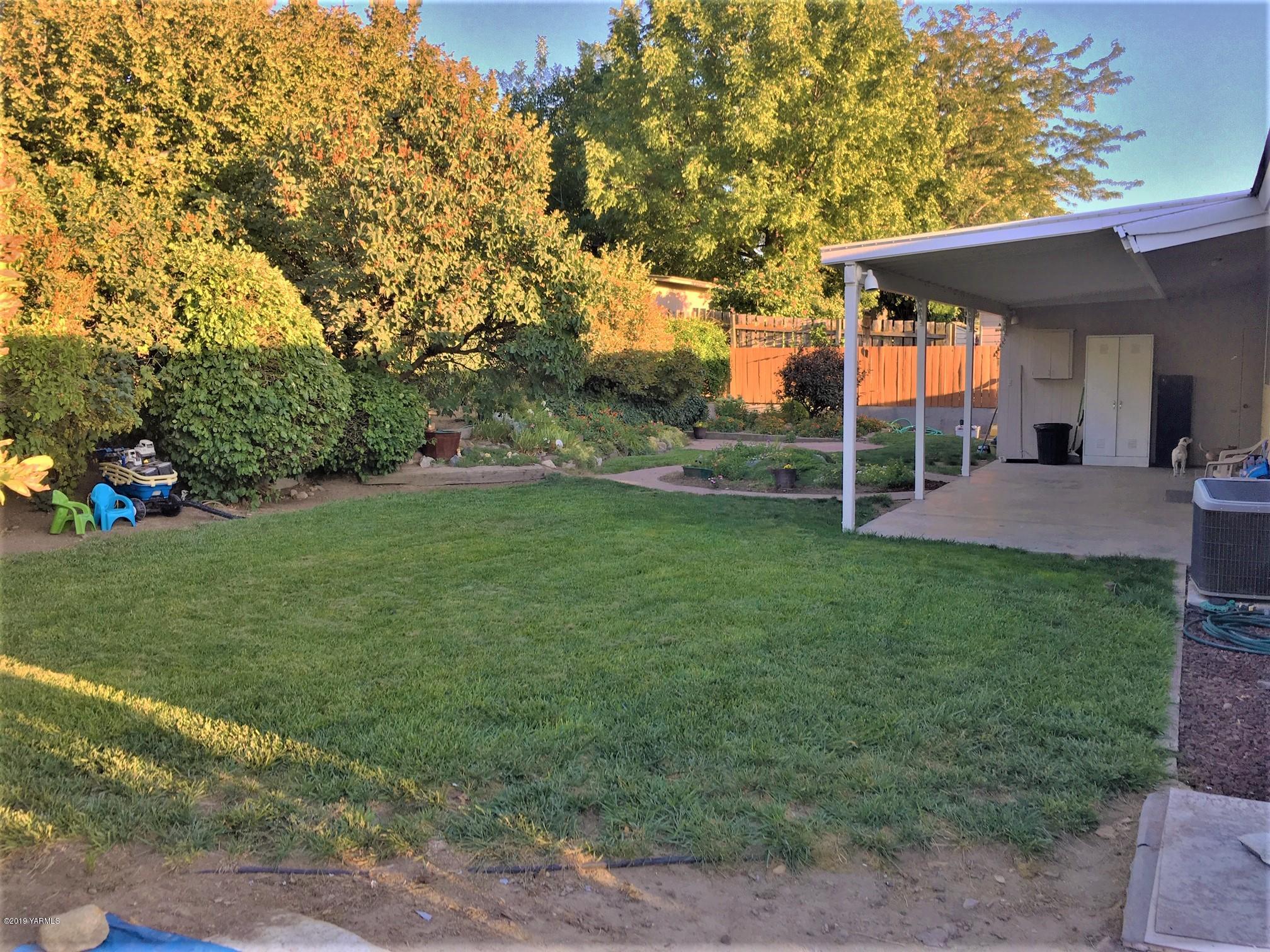 1220 Swan Road Sunnyside, WA 98944 - Photo 19 of 22 a view of a house with a backyard porch and sitting area