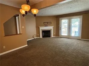 a view of empty room with a fireplace