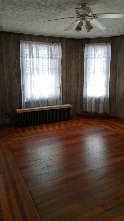 315 Mott Street Fall River, MA 02721 - Photo 14 of 20 a view of empty room with wooden floor and fan