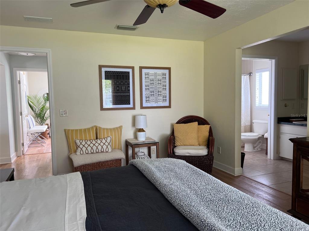 12595 Southeast Sunset Harbor Road Weirsdale, FL 32195 - Photo 16 of 25 a bedroom with a bed and wooden floor