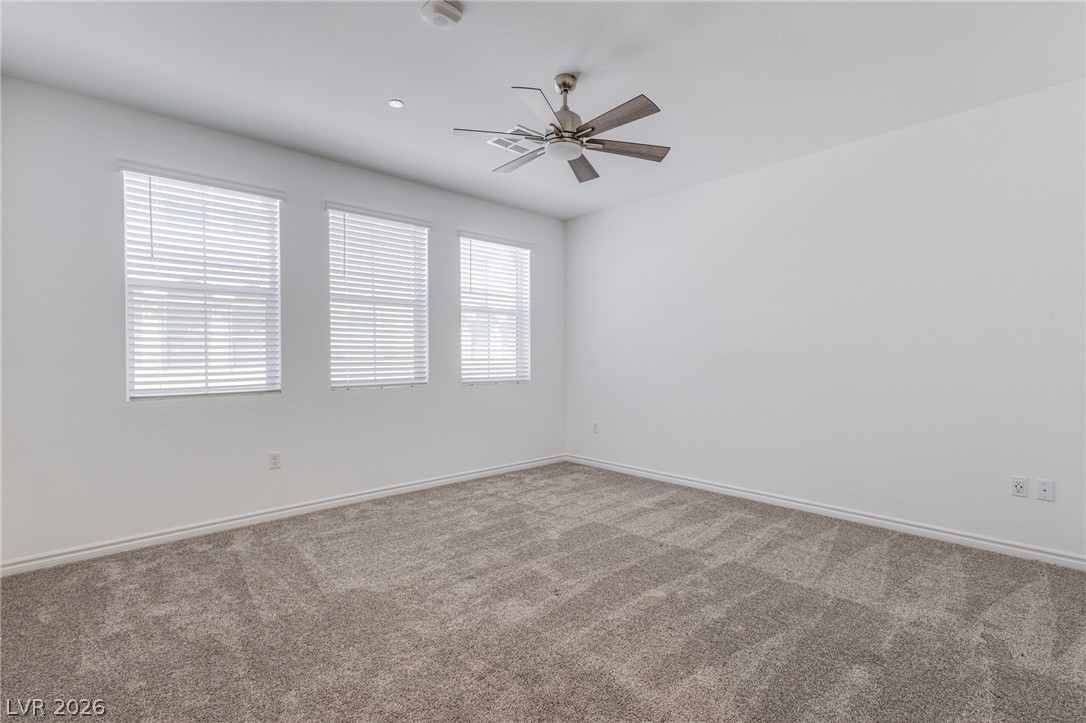 2555 Hampton Road, Unit 8206 Henderson, NV 89052 - Photo 15 of 25 A spacious room features plush carpeting and multiple windows for abundant natural illumination.