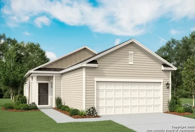 a view of a white house next to a yard and large trees