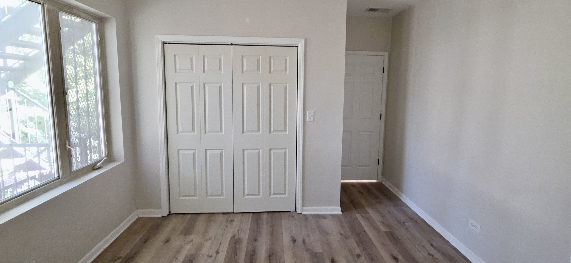 6439 South St Lawrence Avenue, Unit 2 Chicago, IL 60637 - Photo 5 of 8 a view of a hallway with wooden floor and a window