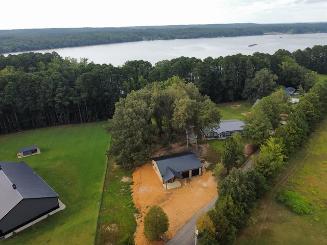 an aerial view of a house with a yard