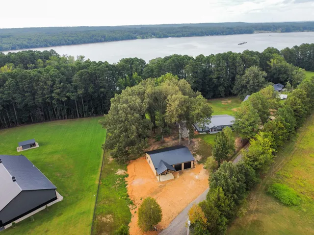 an aerial view of a house with a yard