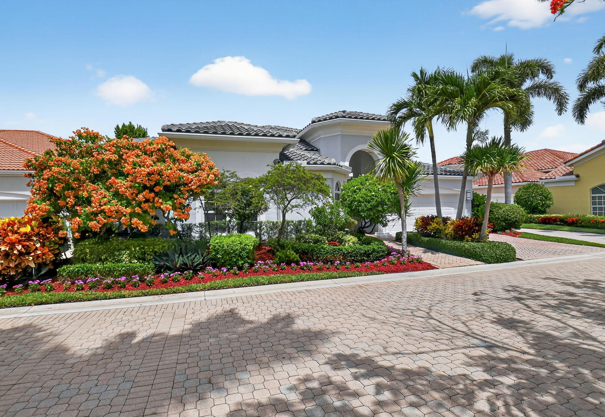 6535 Somerset Circle Boca Raton, FL 33496 - Photo 2 of 59 a front view of a house with a garden and a yard