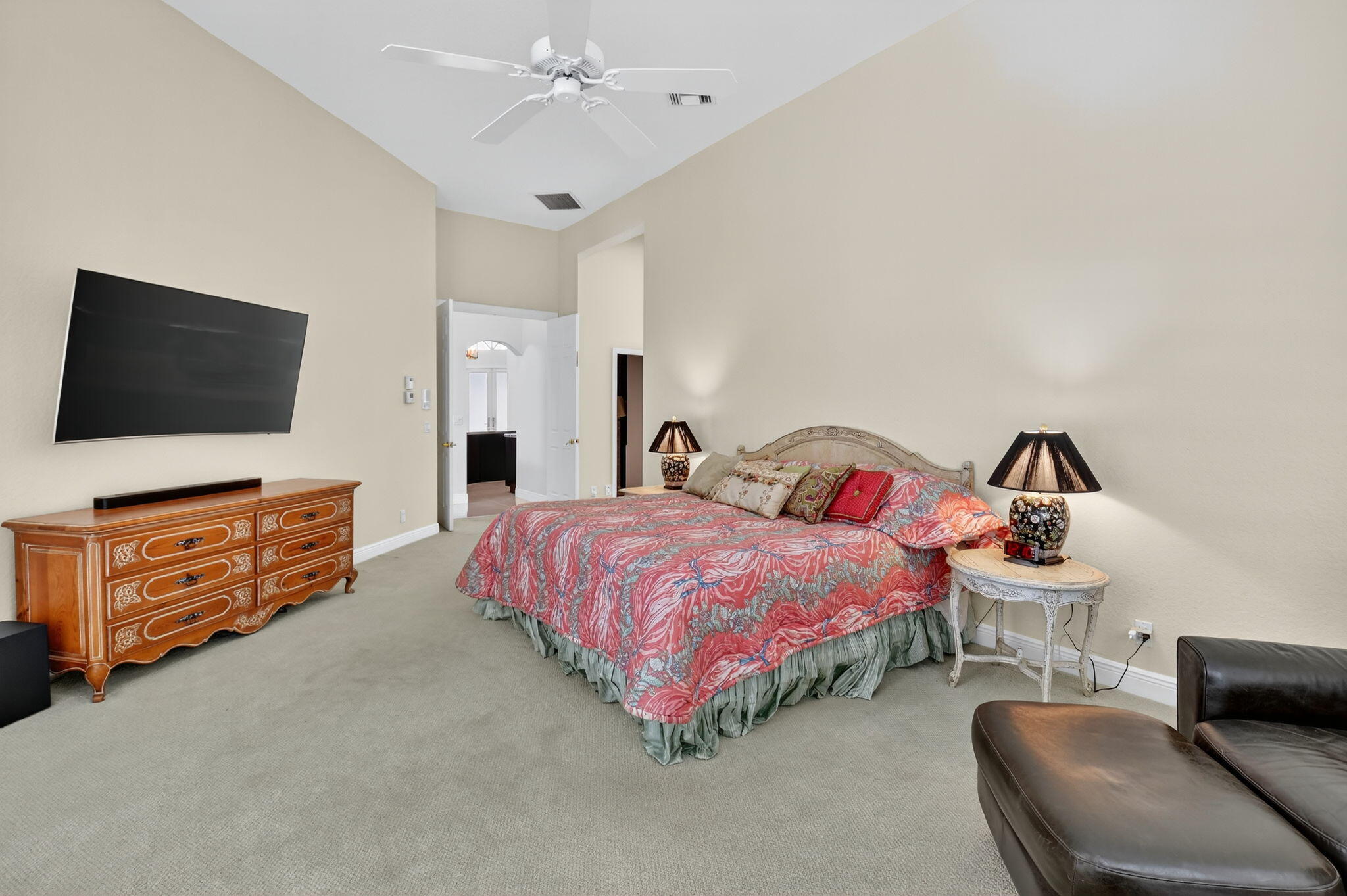6535 Somerset Circle Boca Raton, FL 33496 - Photo 30 of 59 a spacious bedroom with a bed and a flat screen tv