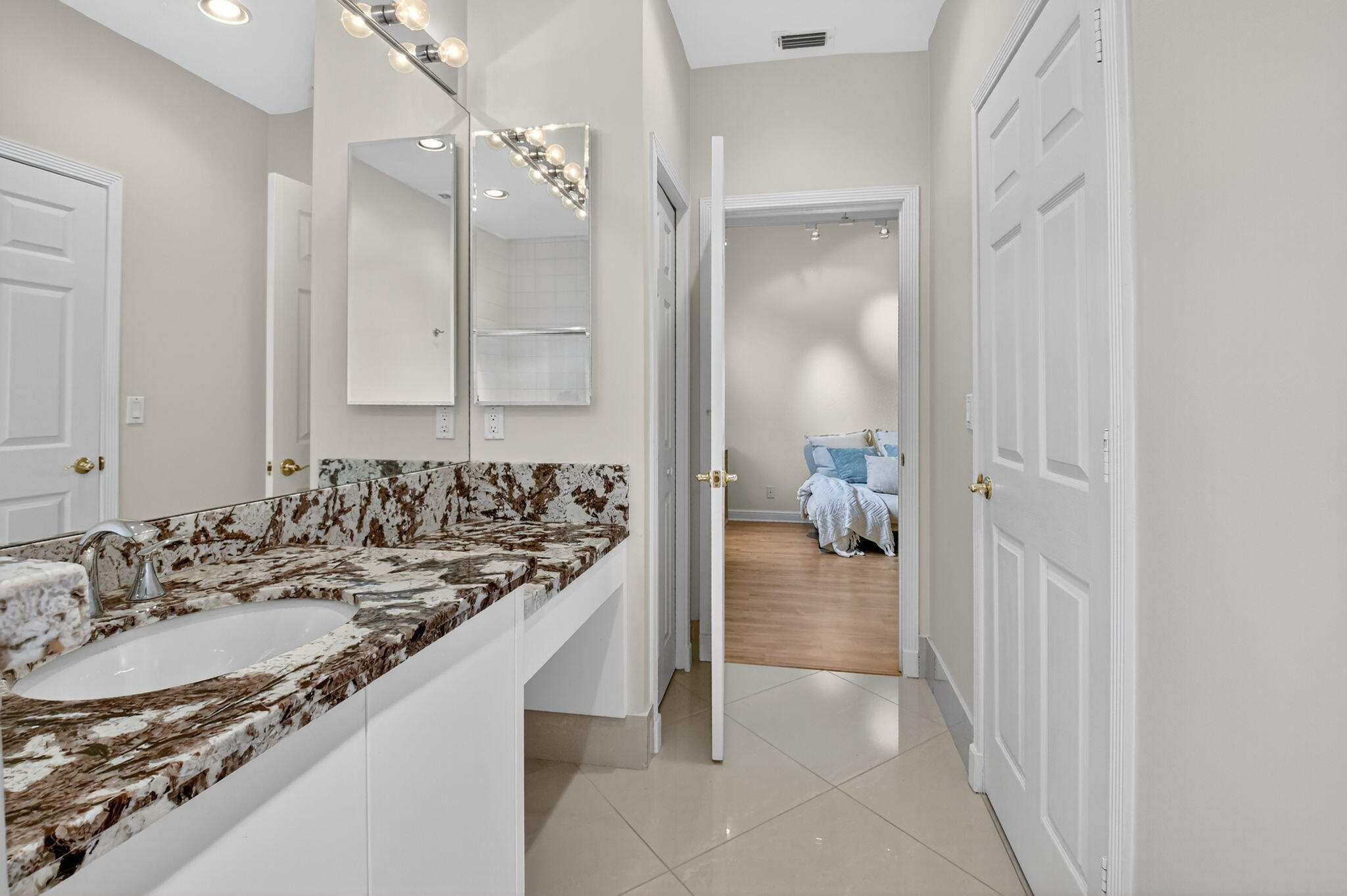 6535 Somerset Circle Boca Raton, FL 33496 - Photo 43 of 59 a en suite bathroom with a sink and a mirror