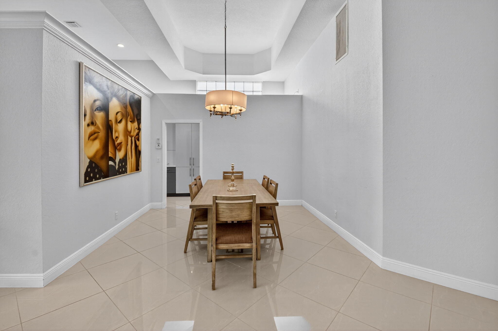 6535 Somerset Circle Boca Raton, FL 33496 - Photo 6 of 59 a dining room with wooden floor and a chandelier