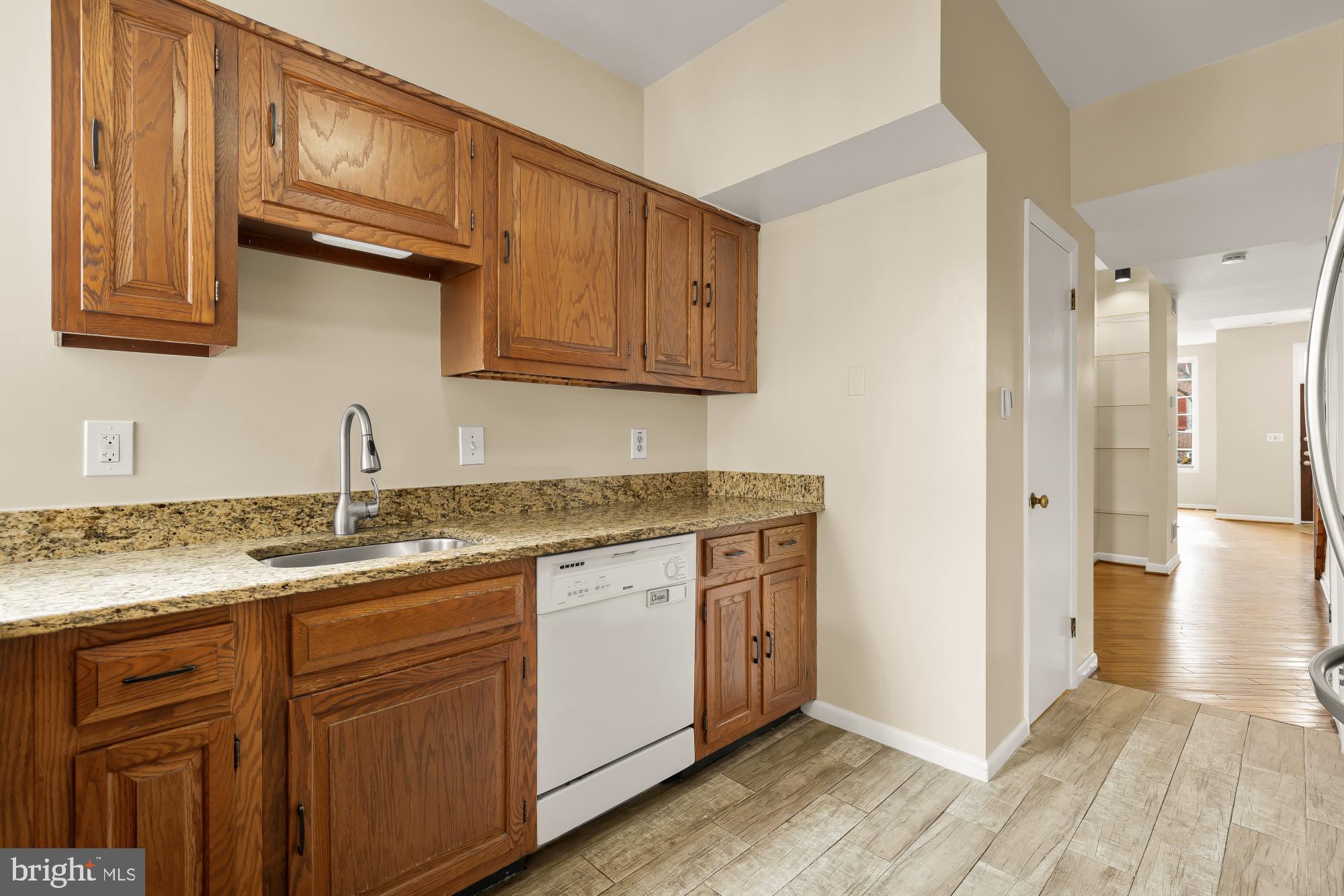650 E Street Northeast, Unit A Washington, DC 20002 - Photo 11 of 31 a kitchen with stainless steel appliances granite countertop a sink stove and cabinets