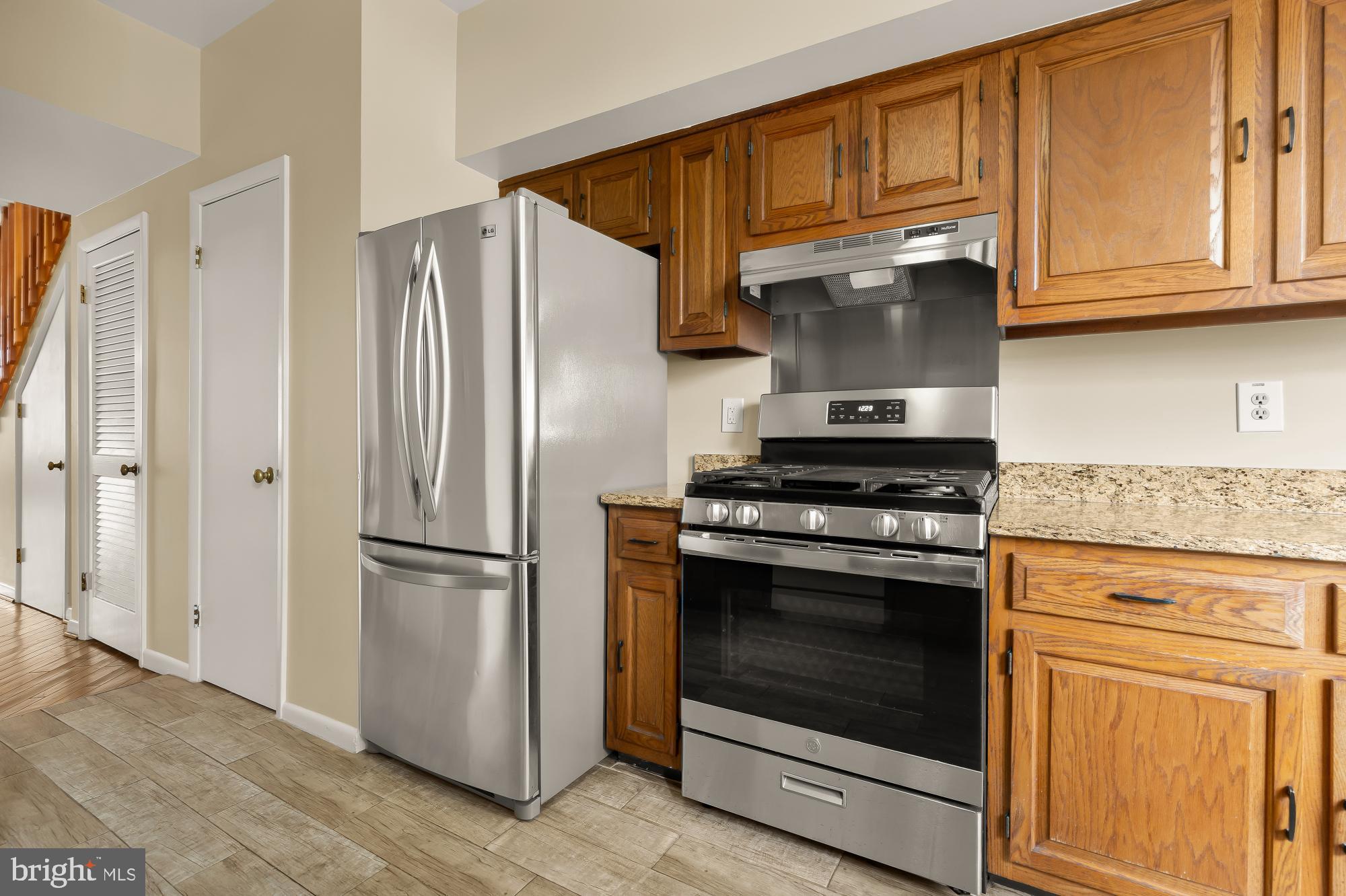 650 E Street Northeast, Unit A Washington, DC 20002 - Photo 13 of 31 a kitchen with granite countertop stainless steel appliances and wooden cabinets