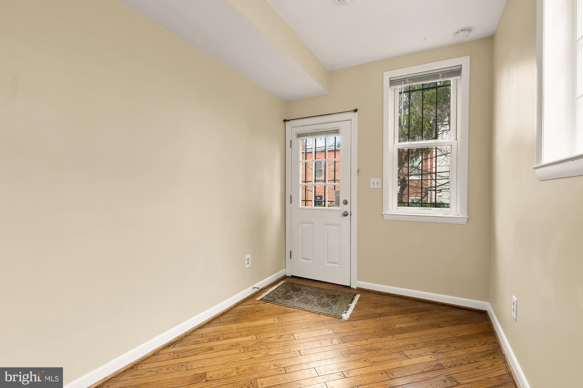 650 E Street Northeast, Unit A Washington, DC 20002 - Photo 14 of 31 an empty room with wooden floor and windows