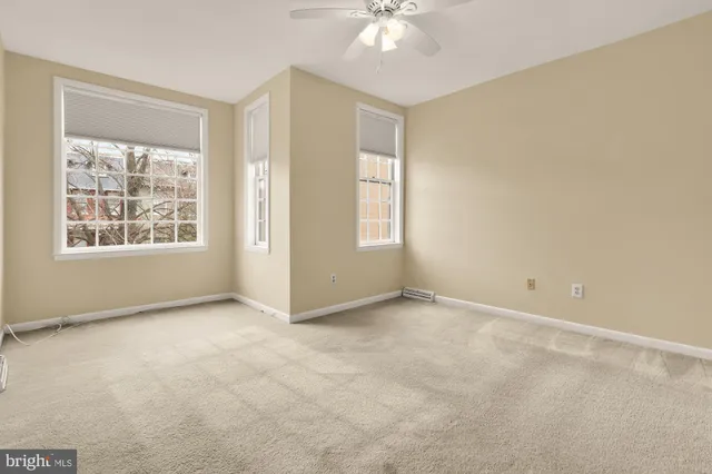 a view of an empty room with windows