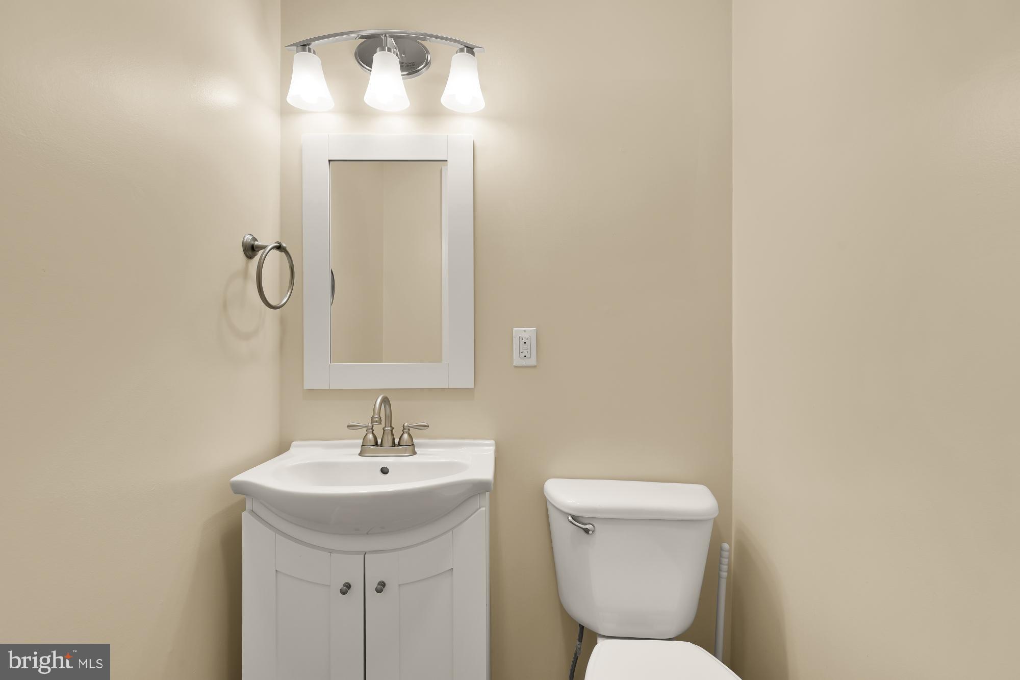 650 E Street Northeast, Unit A Washington, DC 20002 - Photo 7 of 31 a bathroom with a toilet sink and mirror