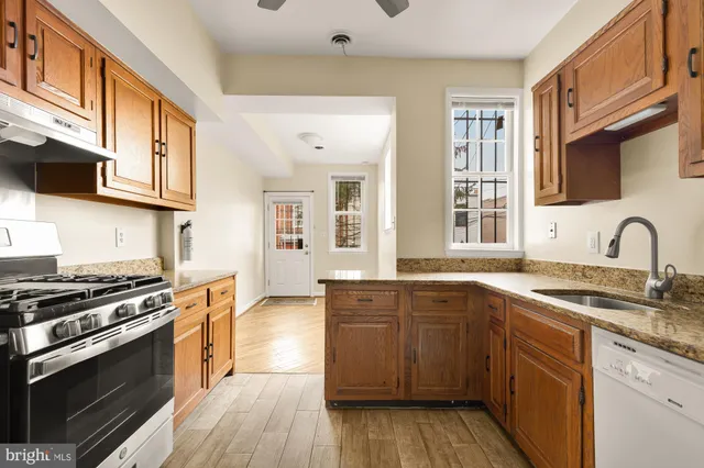 a kitchen with stainless steel appliances granite countertop a stove and a sink