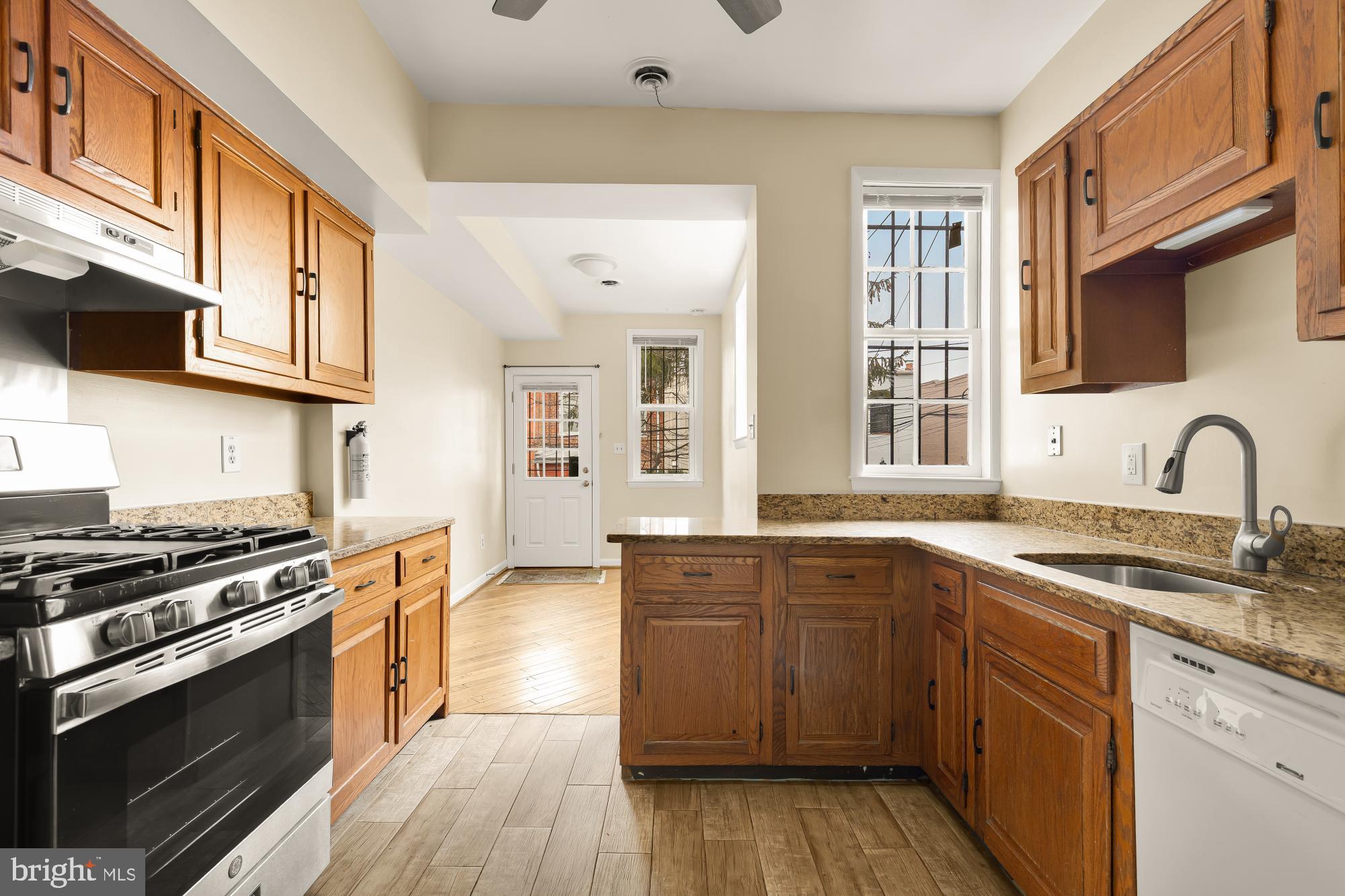 650 E Street Northeast, Unit A Washington, DC 20002 - Photo 9 of 31 a kitchen with stainless steel appliances granite countertop a stove and a sink
