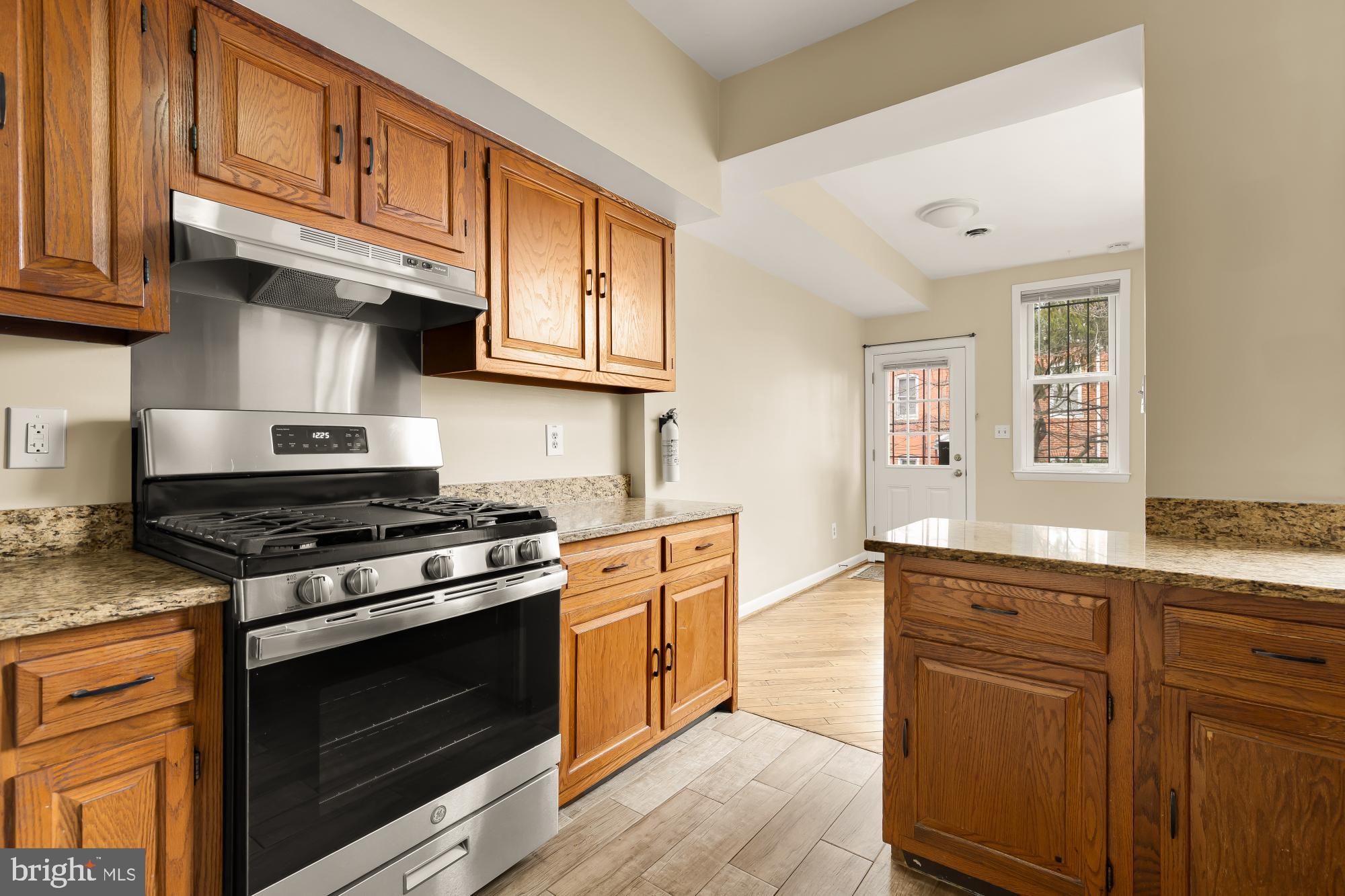 650 E Street Northeast, Unit A Washington, DC 20002 - Photo 10 of 31 a kitchen with stainless steel appliances granite countertop a stove and a sink
