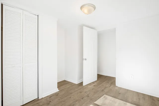 a view of a room with wooden floor