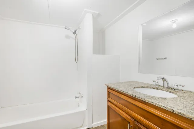 a bathroom with a granite countertop sink and a granite counter top