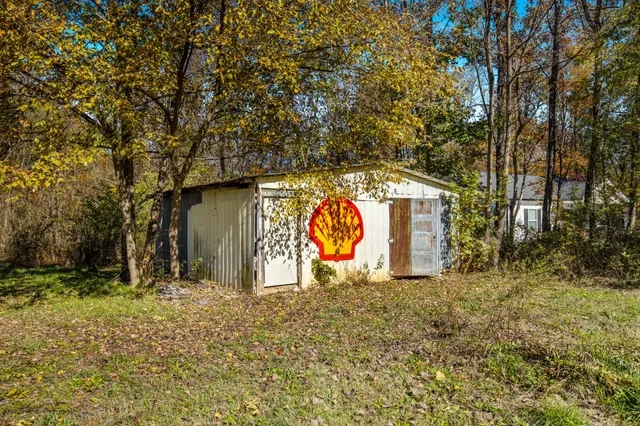 a wooden house with trees in front of it