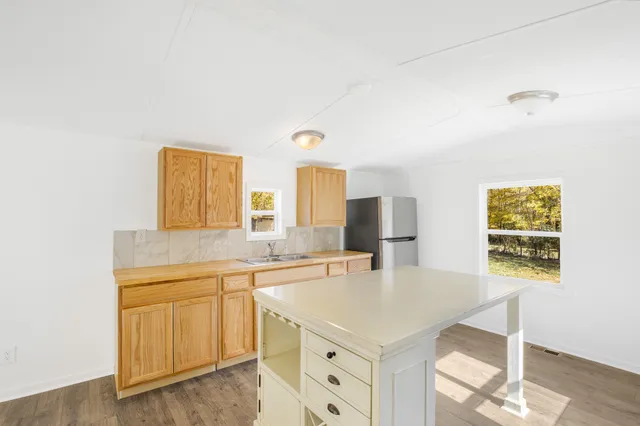 a kitchen with a sink cabinets and window