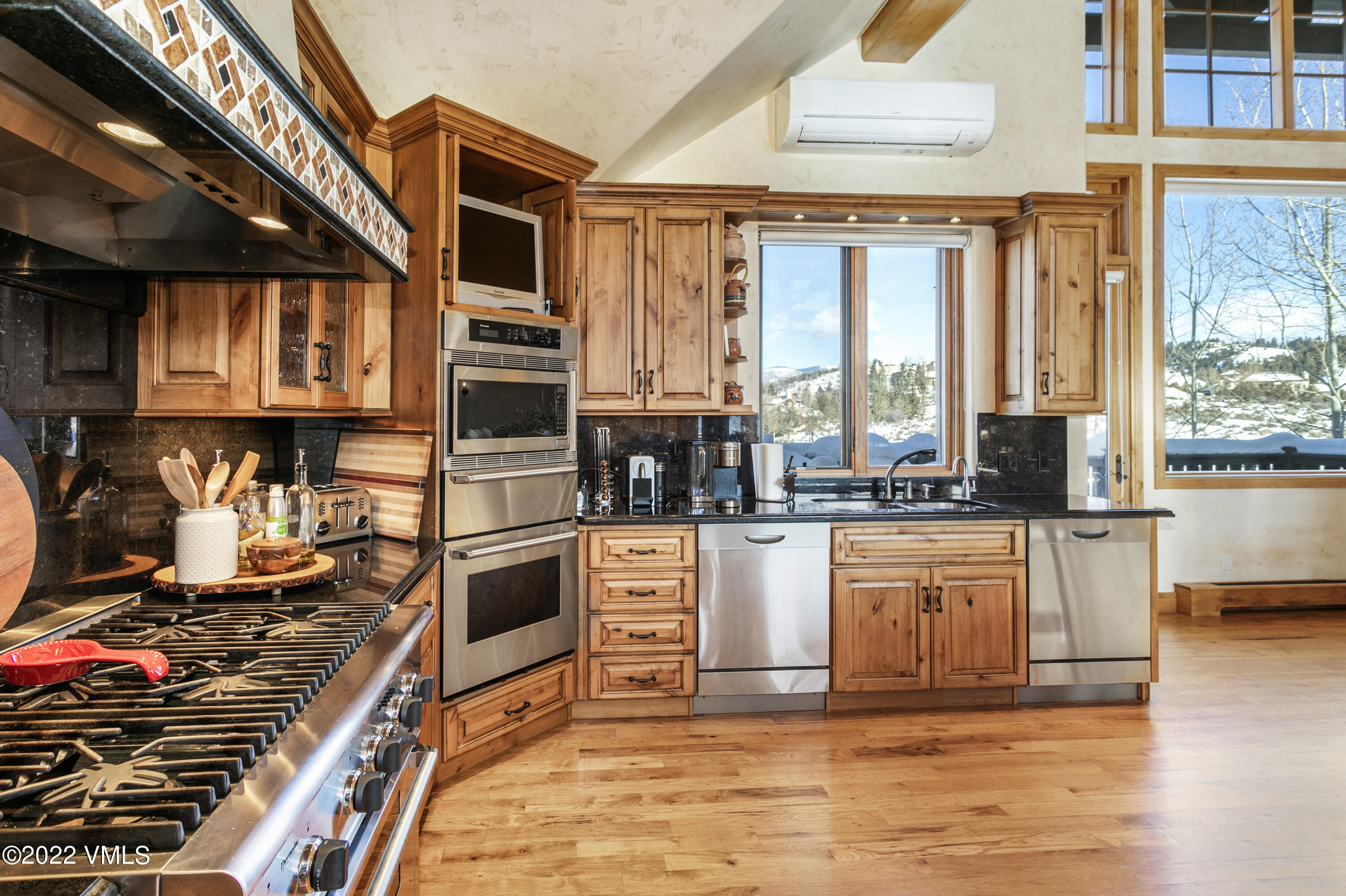 875 Cordillera Way Edwards, CO 81632 - Photo 11 of 57 a kitchen with stainless steel appliances kitchen island granite countertop a stove and a sink