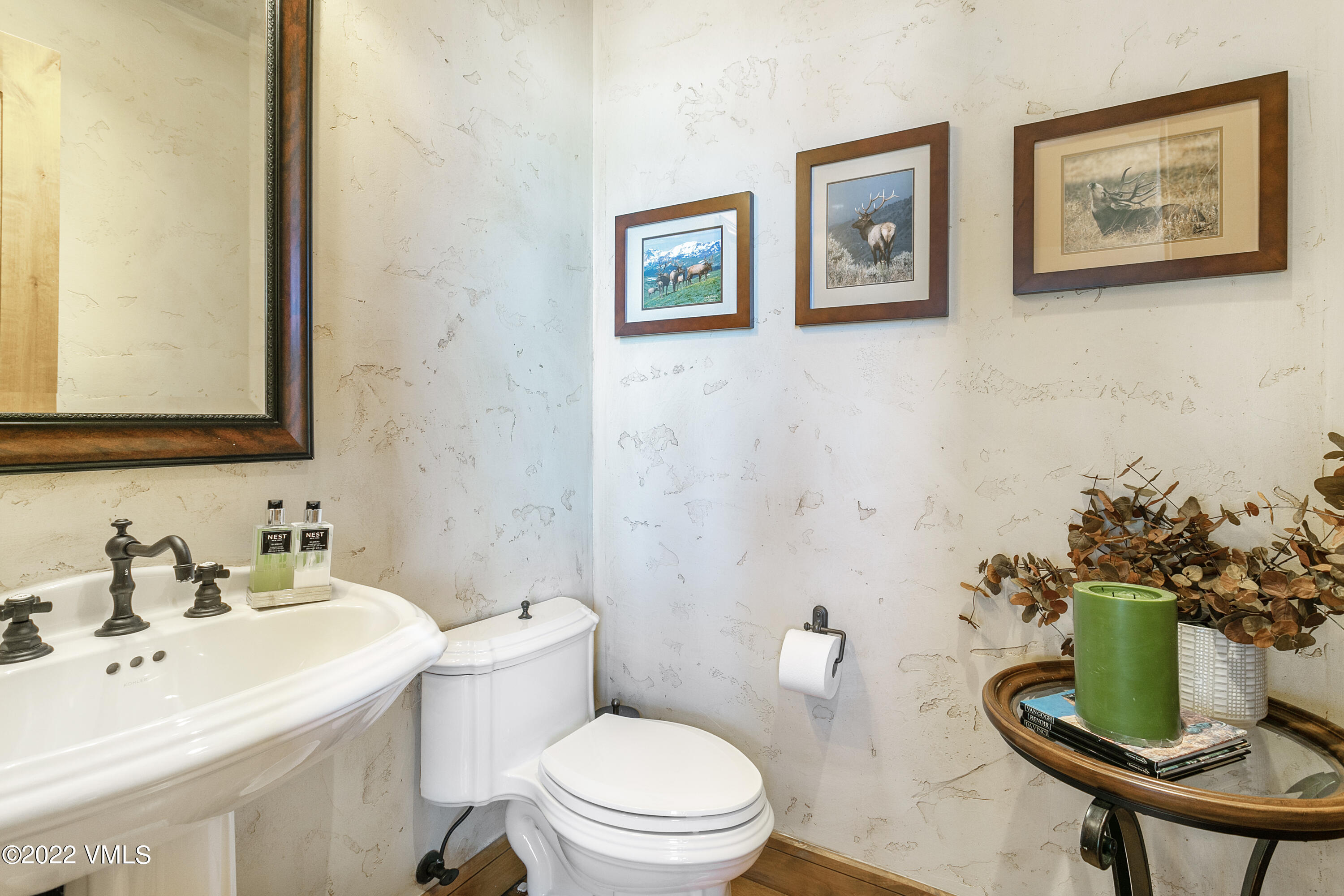 875 Cordillera Way Edwards, CO 81632 - Photo 13 of 57 a bathroom with a toilet a sink and a mirror
