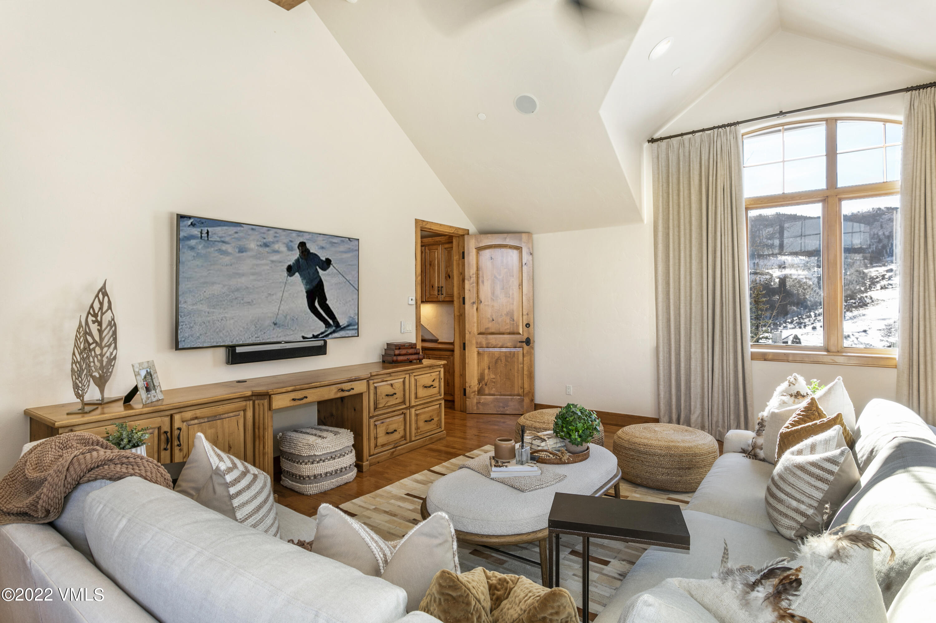 875 Cordillera Way Edwards, CO 81632 - Photo 18 of 57 a living room with furniture a flat screen tv and a large window