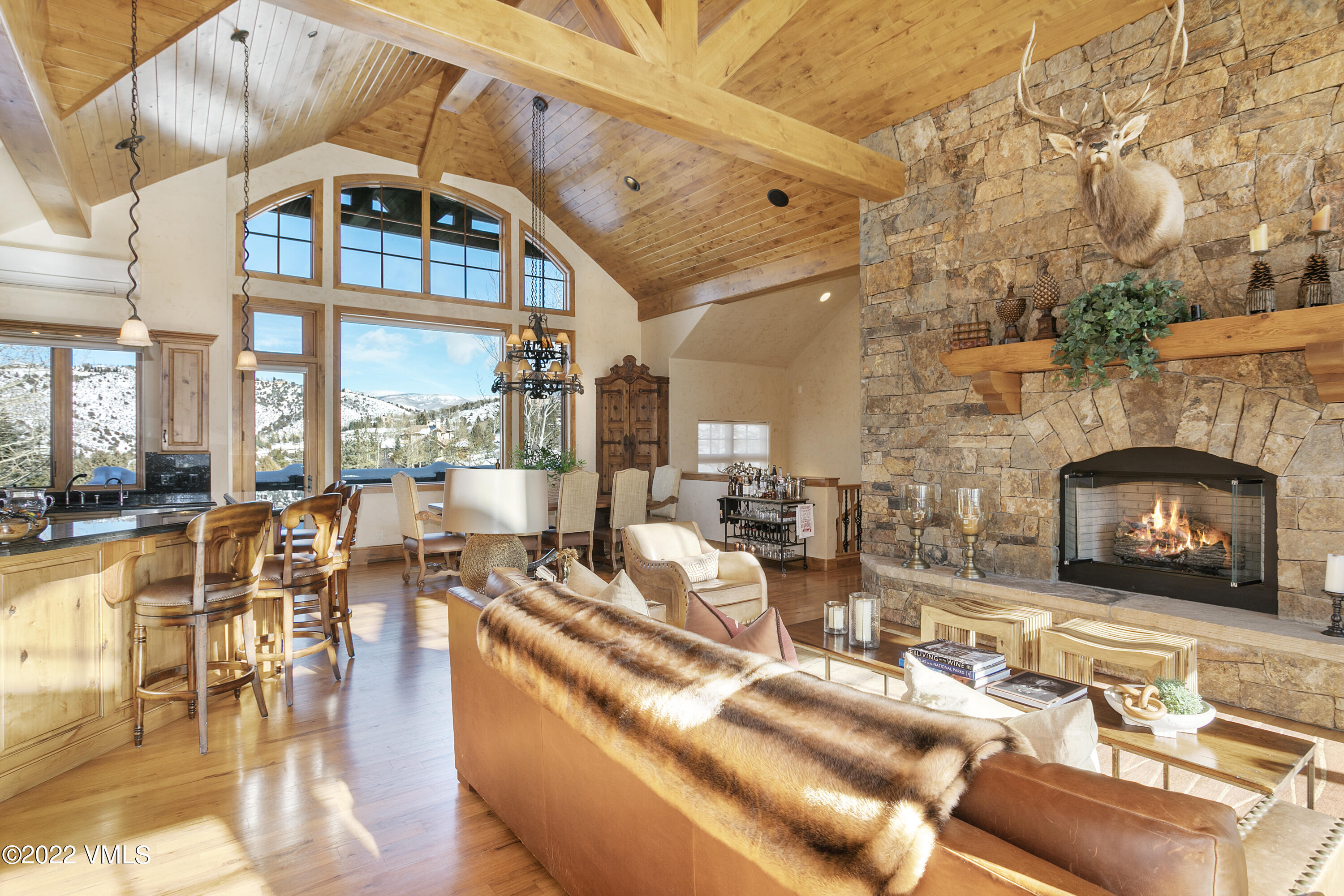 875 Cordillera Way Edwards, CO 81632 - Photo 2 of 57 a living room with fireplace furniture and a floor to ceiling window