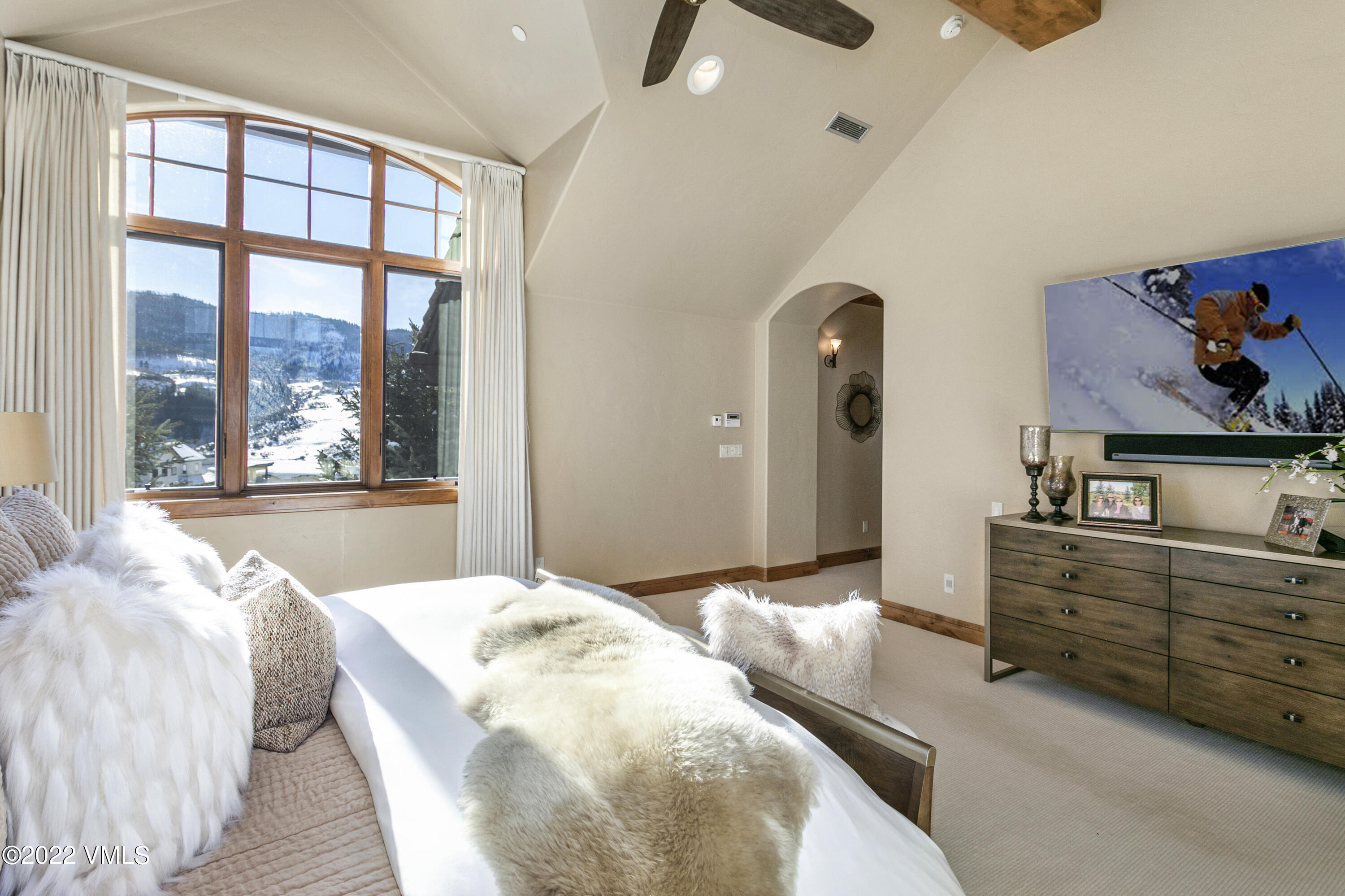 875 Cordillera Way Edwards, CO 81632 - Photo 24 of 57 a spacious bedroom with a large bed and a large window