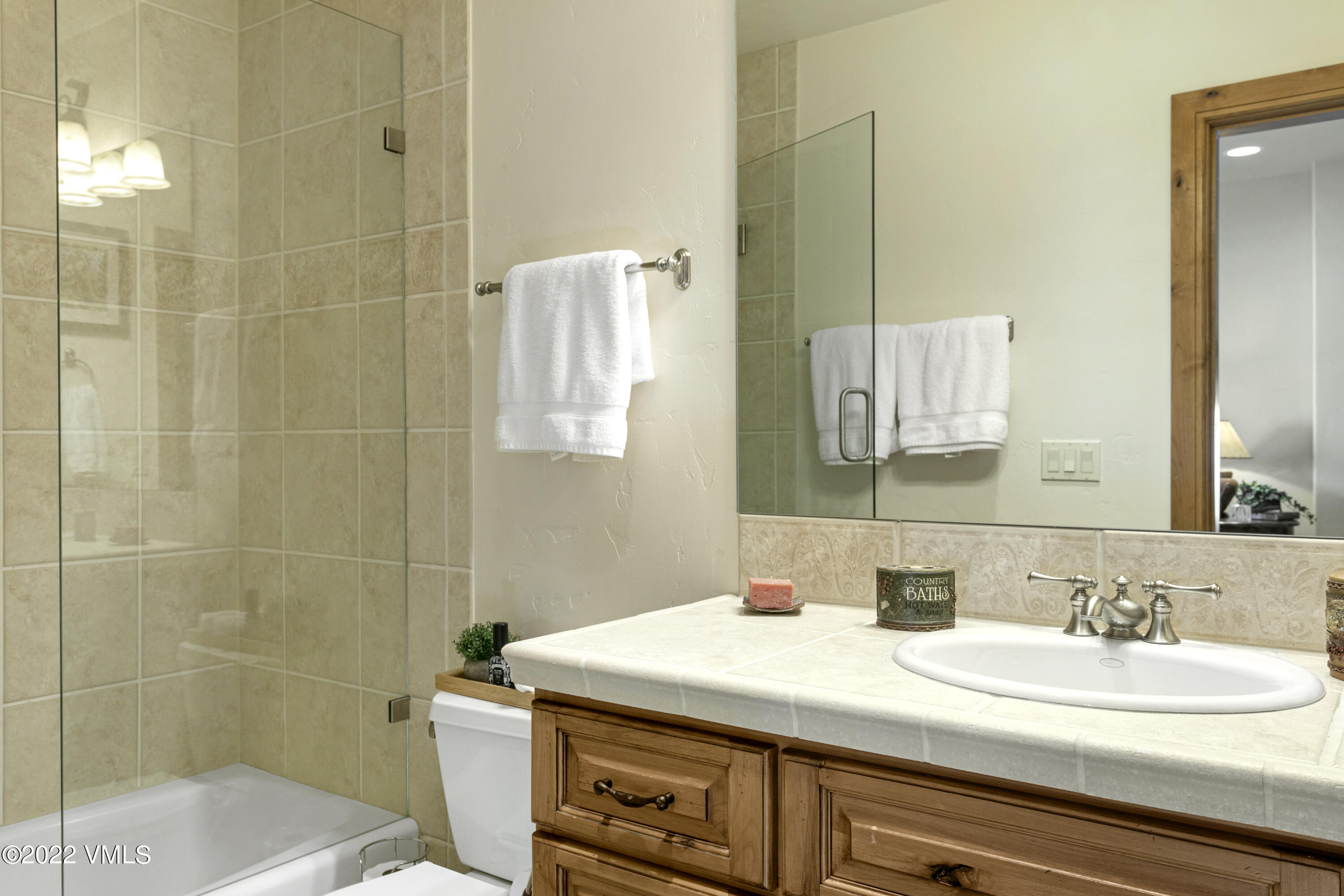875 Cordillera Way Edwards, CO 81632 - Photo 41 of 57 a bathroom with a sink vanity granite and a mirror