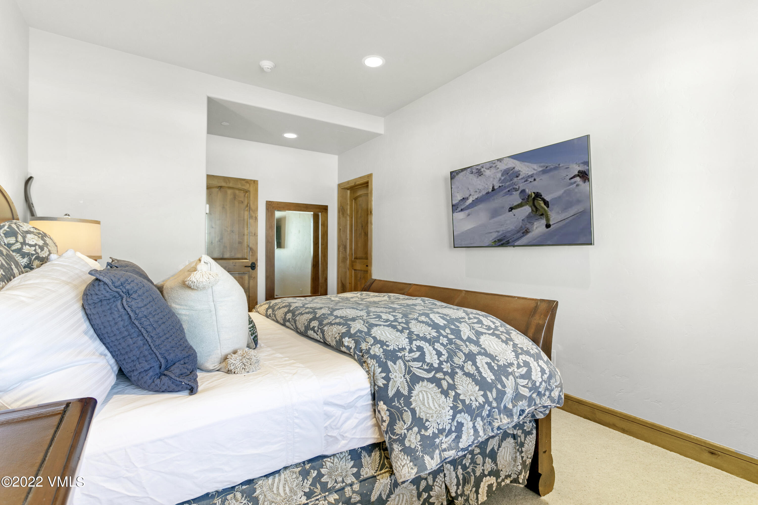 875 Cordillera Way Edwards, CO 81632 - Photo 43 of 57 a bedroom with a bed and a painting on the wall