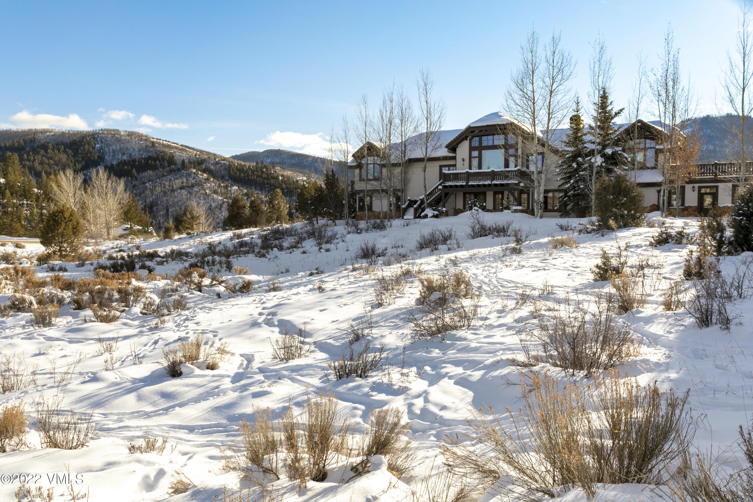 875 Cordillera Way Edwards, CO 81632 - Photo 53 of 57 a front view of a house with a yard covered with snow
