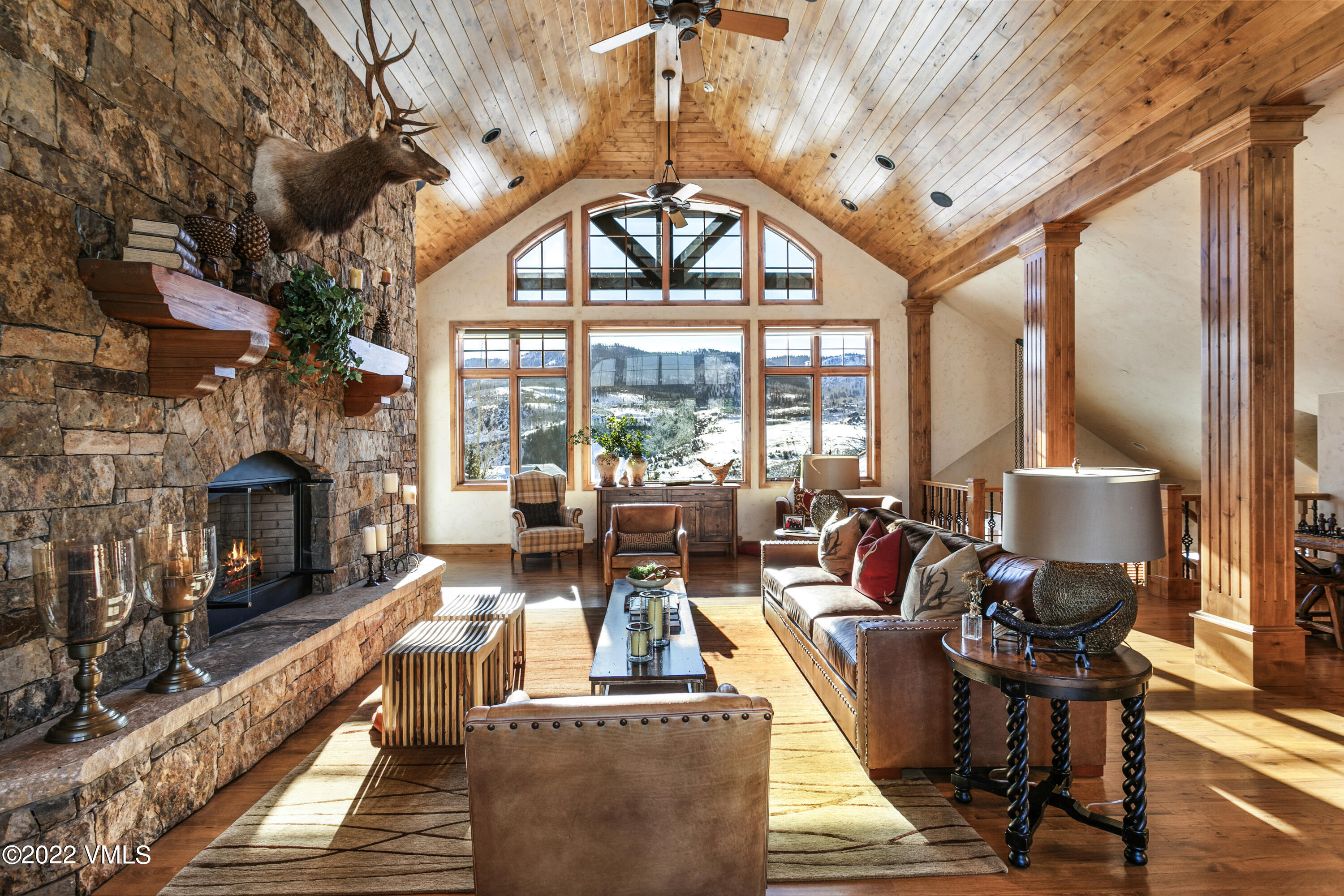 875 Cordillera Way Edwards, CO 81632 - Photo 6 of 57 a living room with furniture a fireplace and a floor to ceiling window