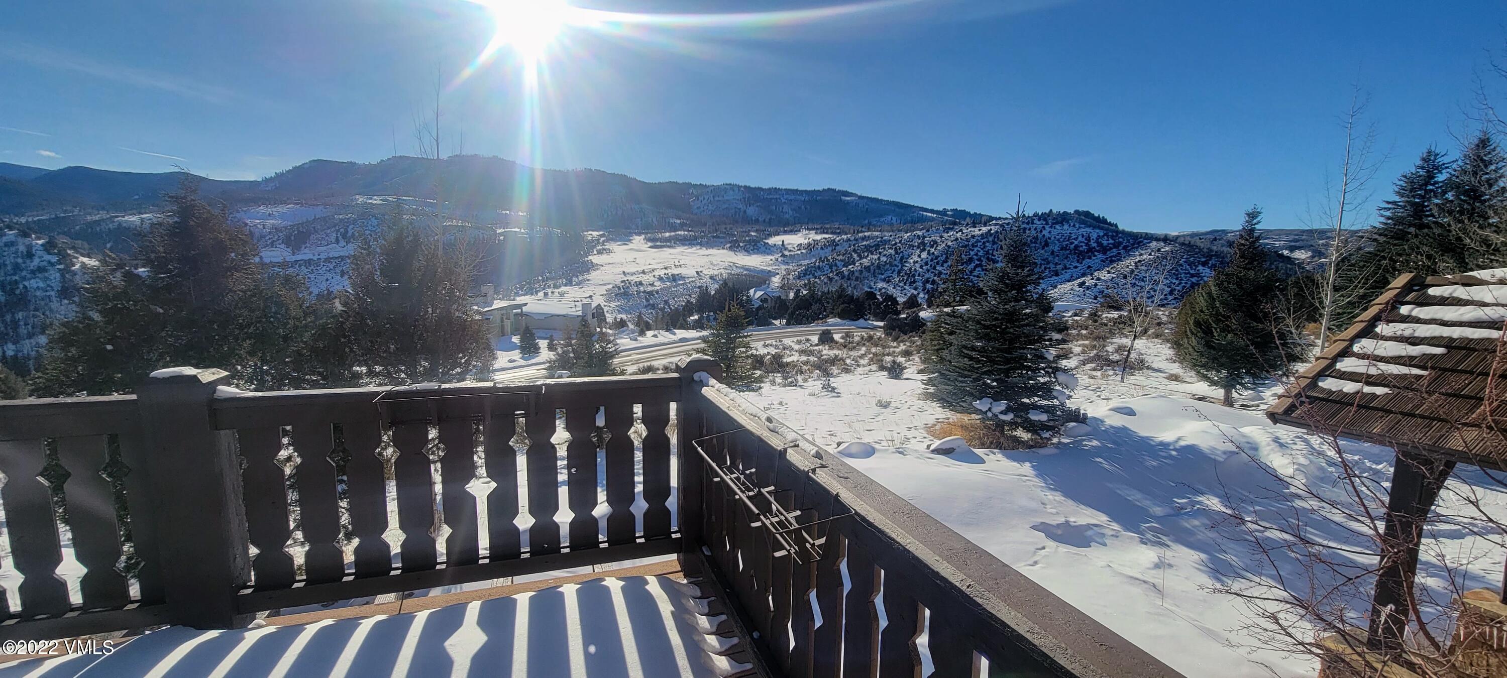 875 Cordillera Way Edwards, CO 81632 - Photo 7 of 57 a view of a balcony with wooden fence and floor