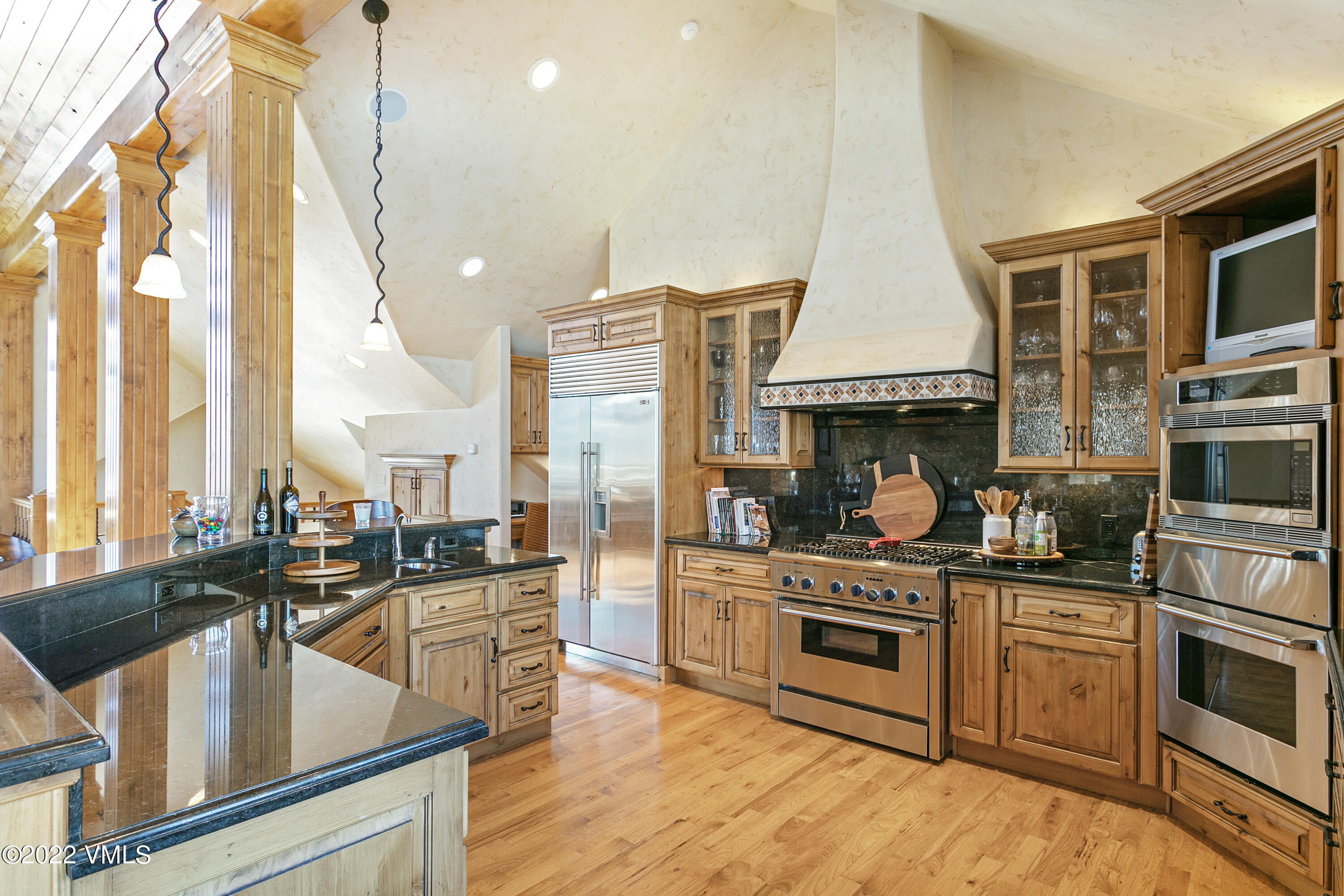 875 Cordillera Way Edwards, CO 81632 - Photo 10 of 57 a kitchen with stainless steel appliances kitchen island granite countertop a stove a sink and white cabinets