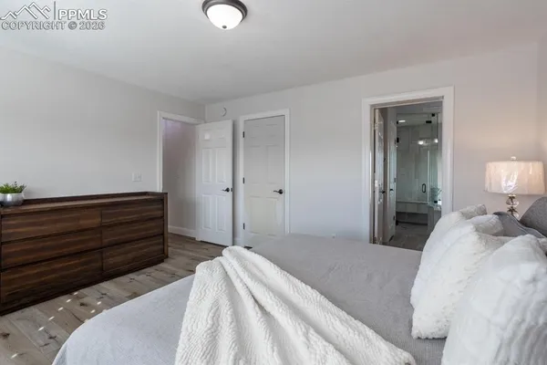 a bedroom with a bed and mirror