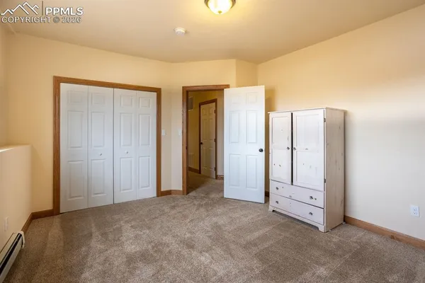 an empty room with closet and mirror