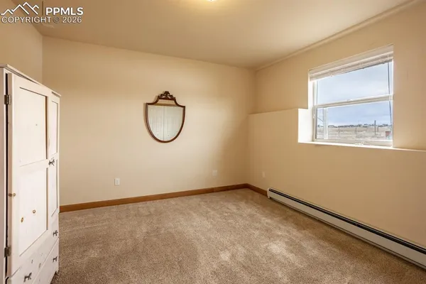a room with window and a fan