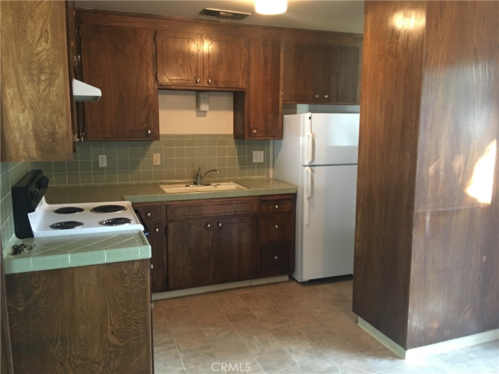 1 Mayfair Drive Chico, CA 95973 - Photo 2 of 4 a kitchen that has a sink and a refrigerator