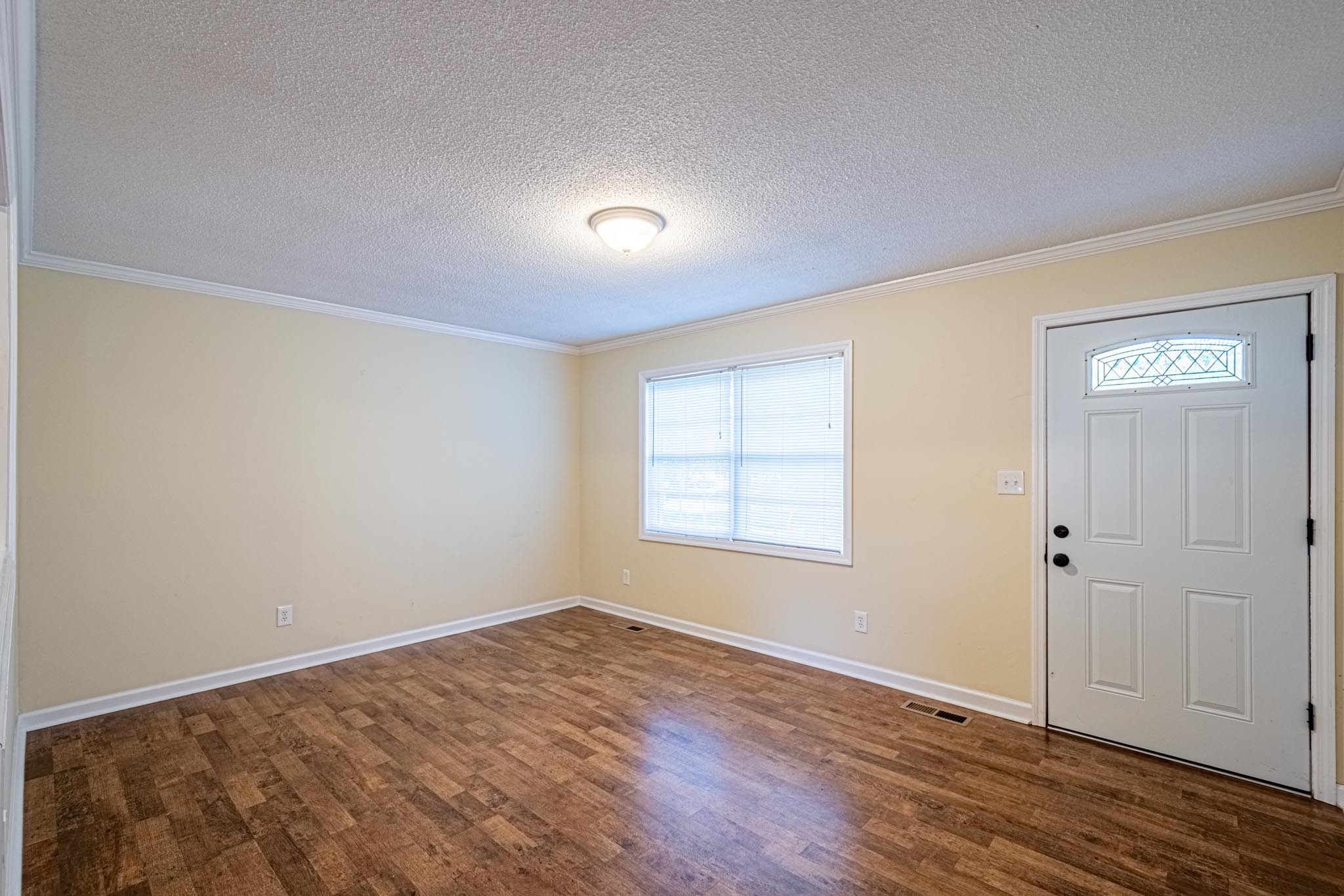 2294 Oak Grove Road Goodspring, TN 38460 - Photo 11 of 40 an empty room with wooden floor and windows