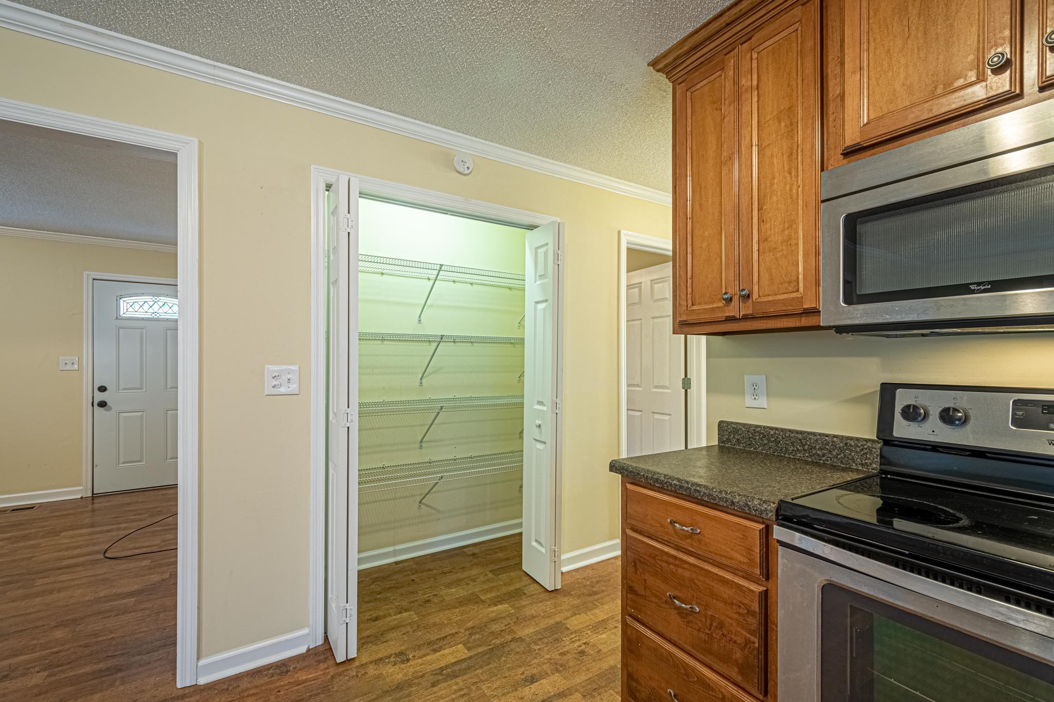 2294 Oak Grove Road Goodspring, TN 38460 - Photo 14 of 40 a kitchen with granite countertop cabinets stainless steel appliances and wooden floor