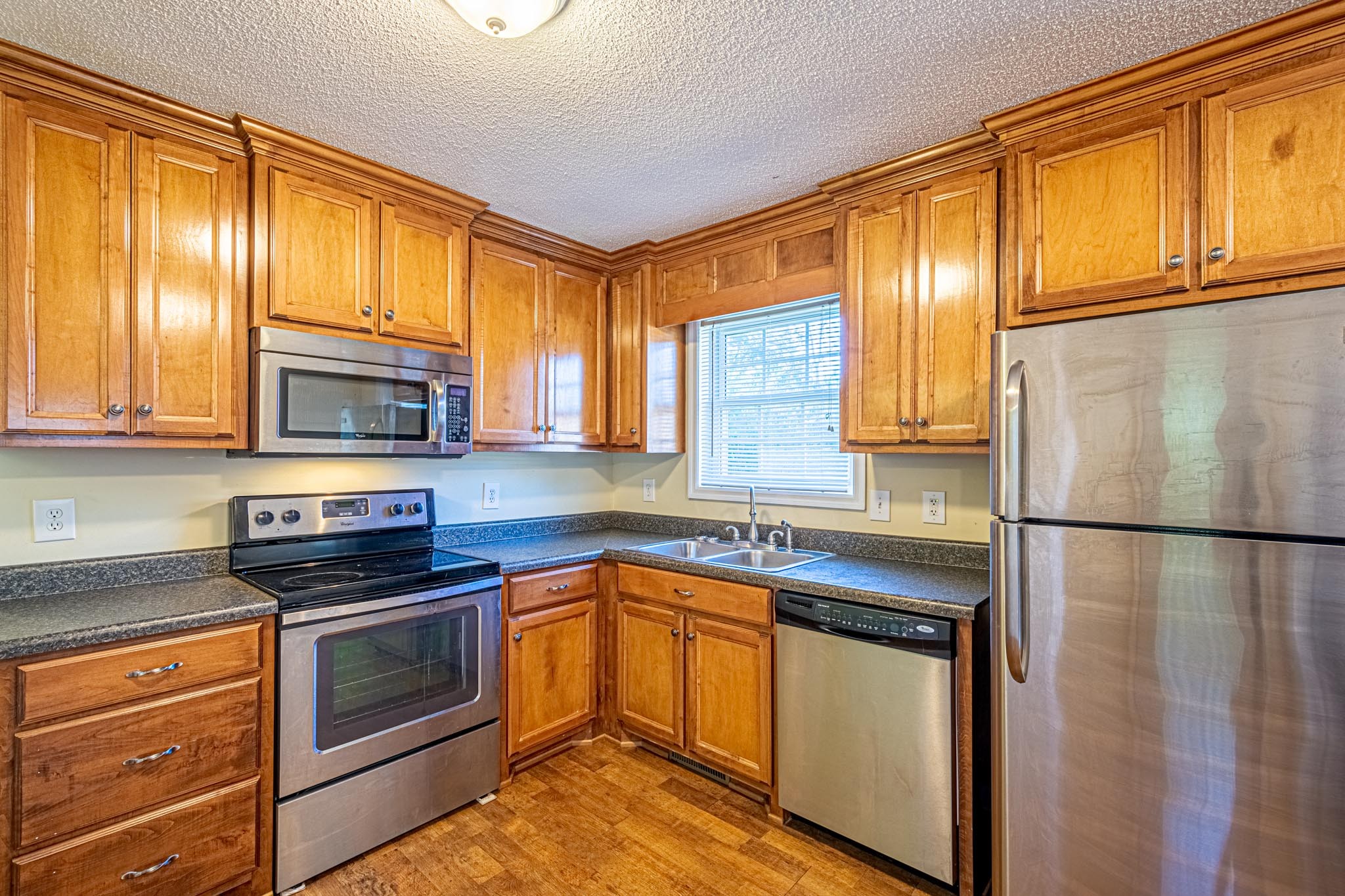 2294 Oak Grove Road Goodspring, TN 38460 - Photo 4 of 40 a kitchen with stainless steel appliances granite countertop a refrigerator a stove a sink and a microwave