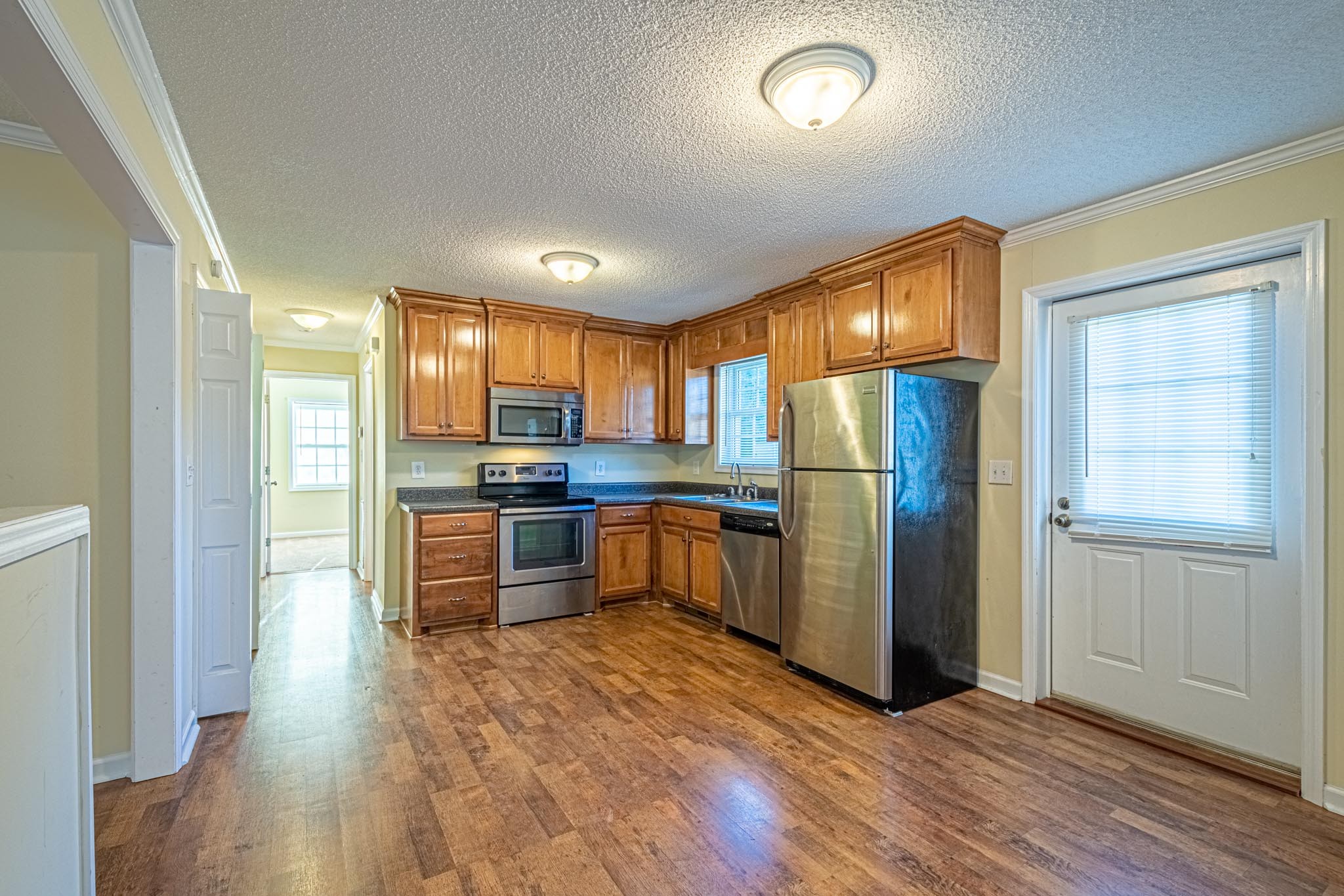 2294 Oak Grove Road Goodspring, TN 38460 - Photo 5 of 40 a kitchen with stainless steel appliances granite countertop a refrigerator oven a sink dishwasher and a refrigerator with wooden floor