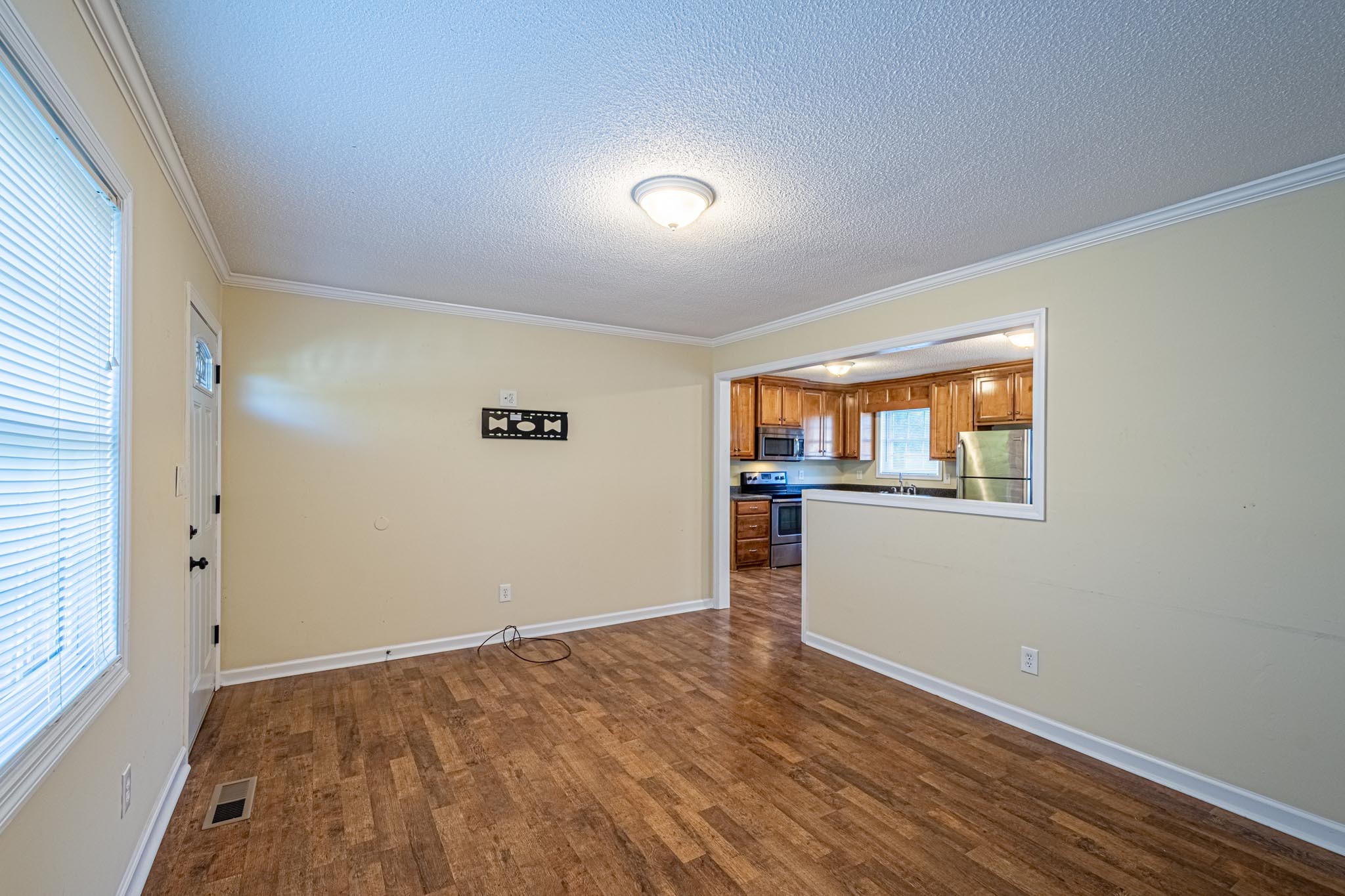 2294 Oak Grove Road Goodspring, TN 38460 - Photo 9 of 40 an empty room with wooden floor and windows